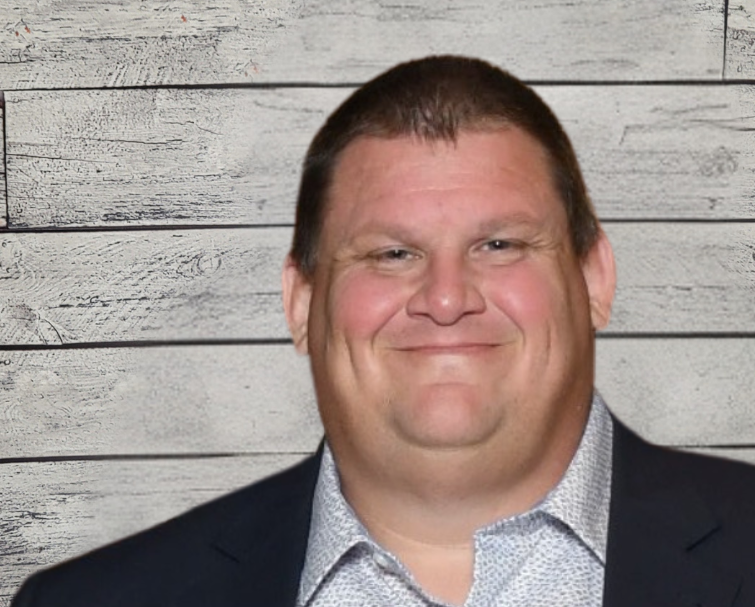 Adam Hayward headshot with wood panel background
