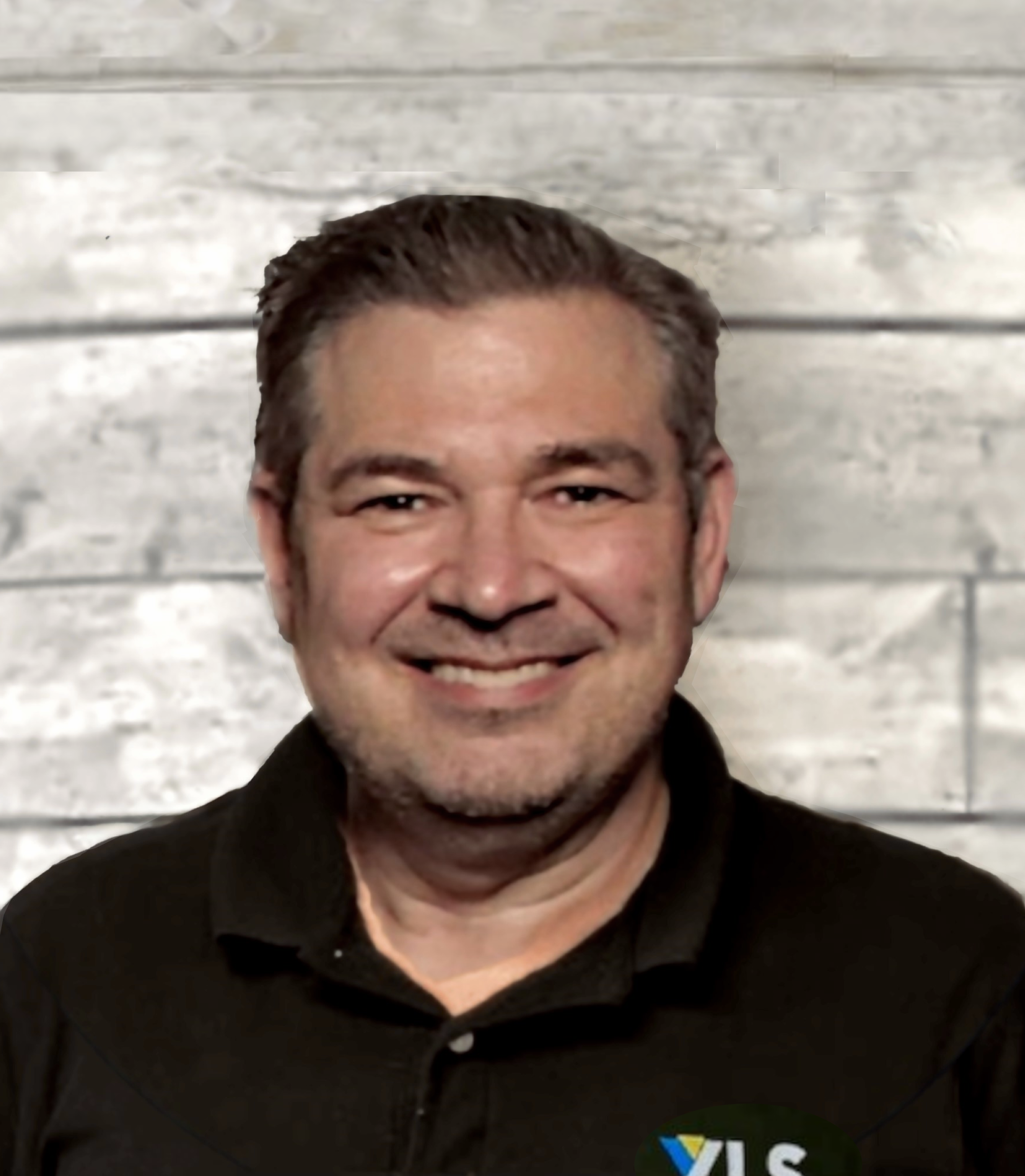 Nick Demore headshot with wood wall background