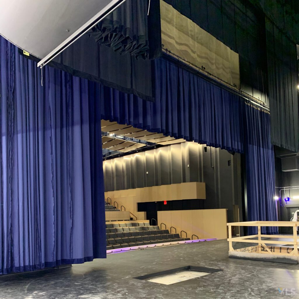 Blue Stage Curtains on Install Rigging over a stage.