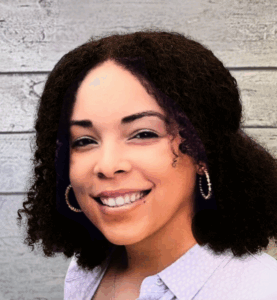 Carolyn Heard headshot on wood panel background