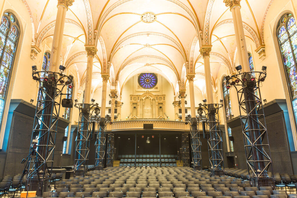 Inside of a cathedral with vaulted white ceilings