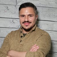 Ben Blanco headshot with wood panel background