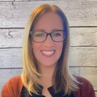 Brittany Vue headshot on wood panel background