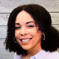 Carolyn Heard headshot on wood panel background