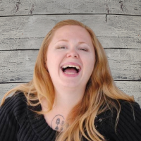 Mandi Stevens headshot on wood panel background